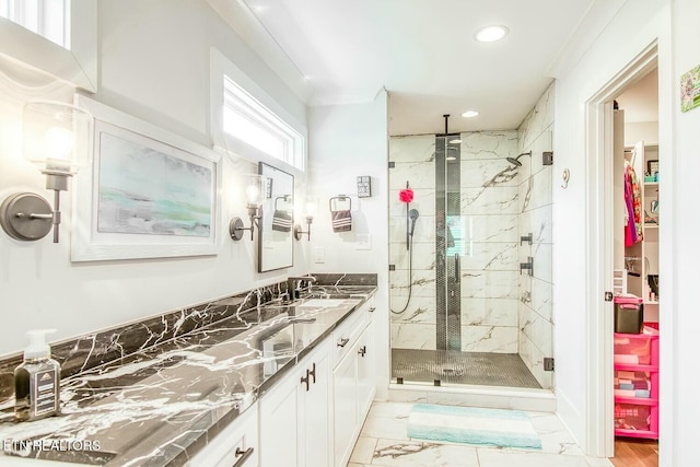 bathroom with marble finish floor, a marble finish shower, vanity, and recessed lighting