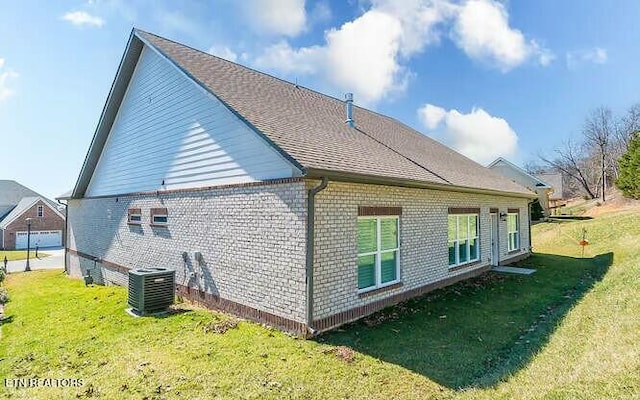 back of property featuring brick siding, a lawn, and cooling unit