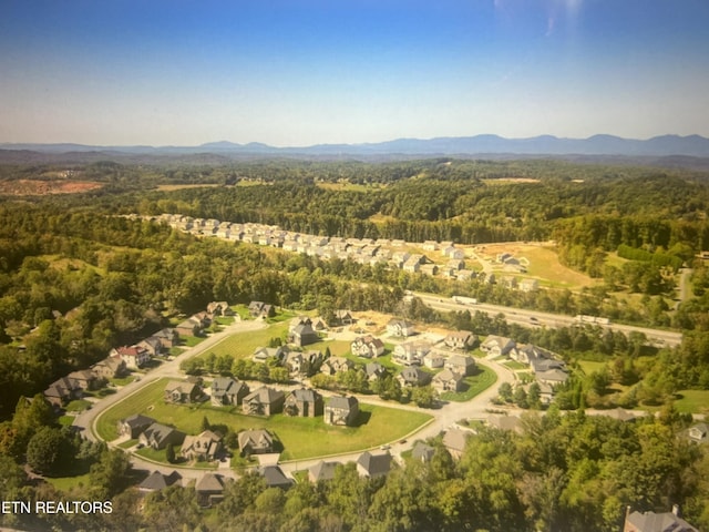 aerial view featuring a mountain view and a wooded view