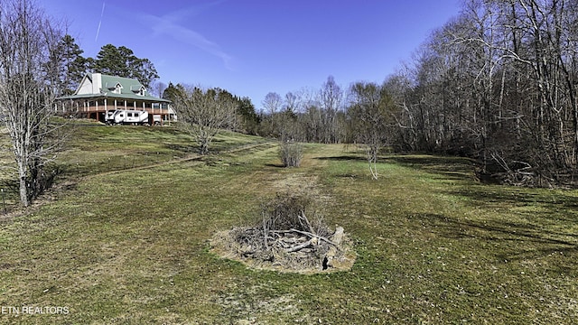 view of yard featuring a carport and a forest view