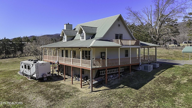 back of house featuring central air condition unit, a chimney, metal roof, and a wooden deck