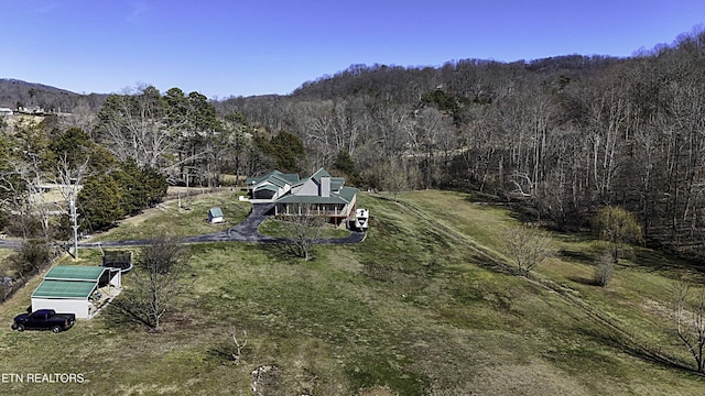 birds eye view of property with a wooded view