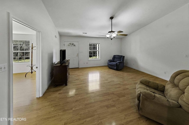 sitting room with light wood-type flooring, ceiling fan, and baseboards