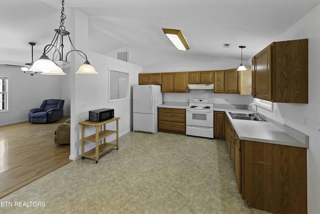 kitchen featuring under cabinet range hood, white appliances, a sink, light countertops, and decorative light fixtures