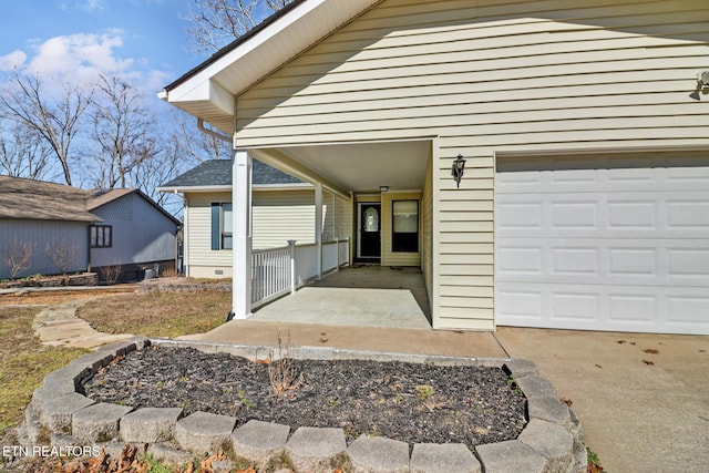 view of exterior entry with a garage and crawl space