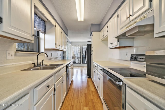 kitchen featuring range with electric cooktop, light countertops, a sink, and under cabinet range hood