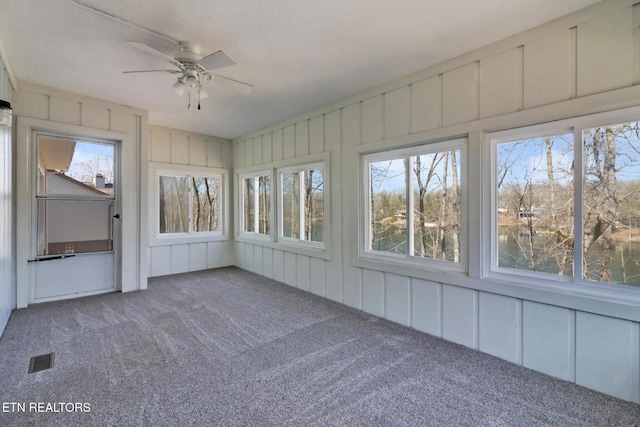 unfurnished sunroom with ceiling fan and visible vents