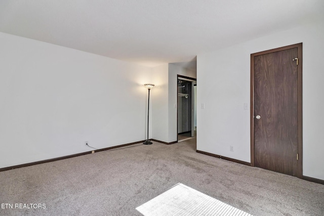 unfurnished bedroom featuring carpet floors and baseboards