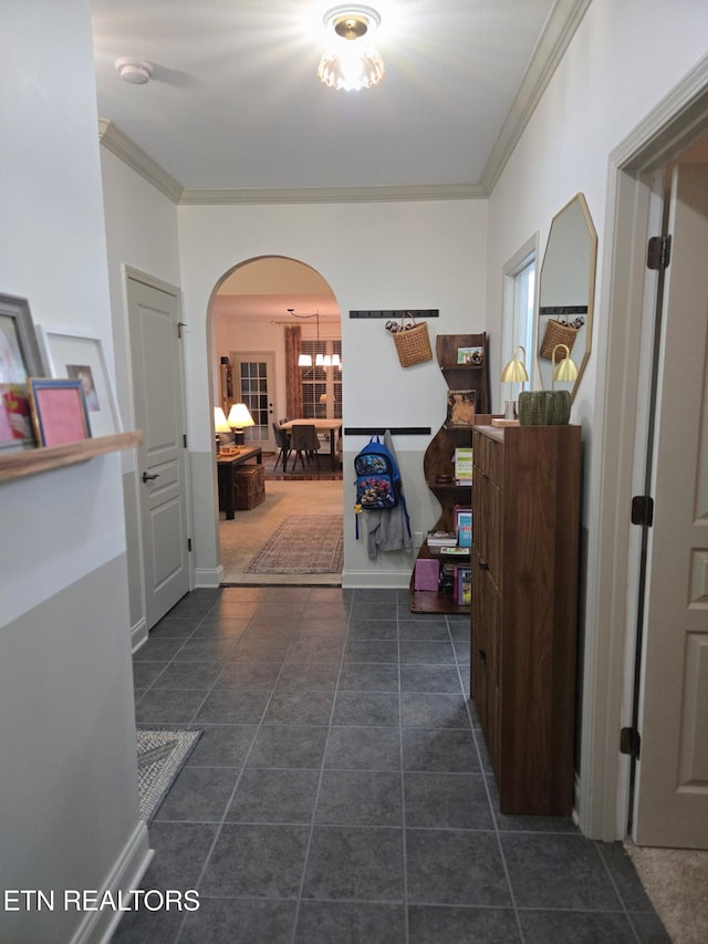 corridor with tile patterned flooring, arched walkways, and crown molding