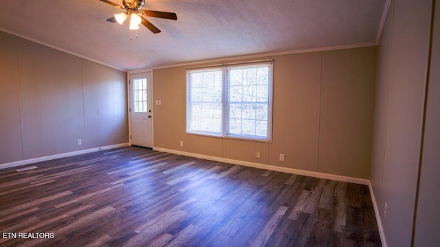 empty room with crown molding, vaulted ceiling, dark wood finished floors, and ceiling fan