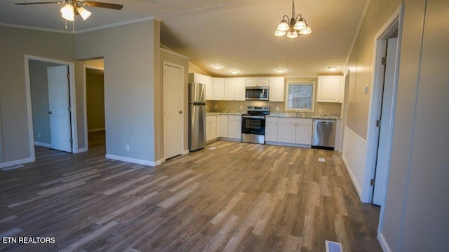 kitchen with dark wood-style floors, crown molding, visible vents, appliances with stainless steel finishes, and white cabinets