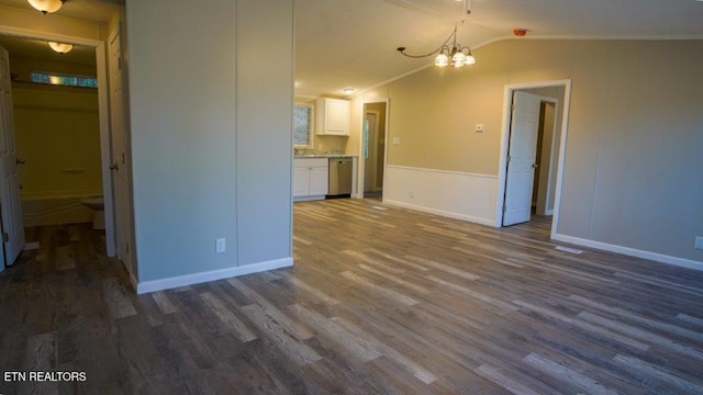 interior space featuring vaulted ceiling, baseboards, dark wood finished floors, and a chandelier