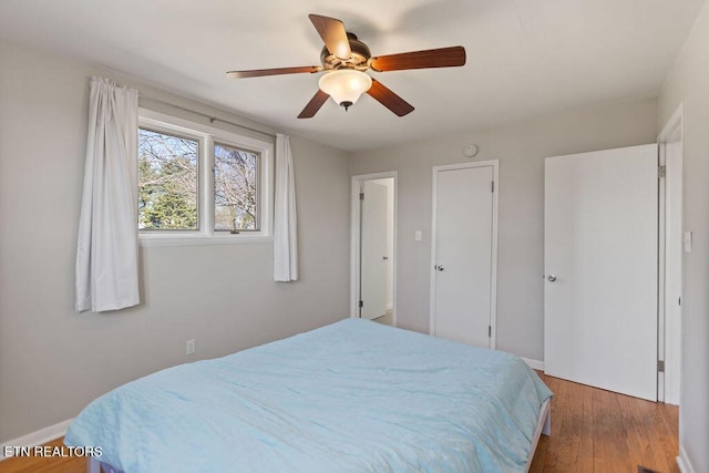 bedroom featuring wood finished floors and a ceiling fan