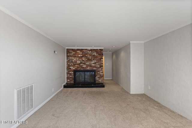 unfurnished living room with visible vents, carpet floors, ornamental molding, and a fireplace