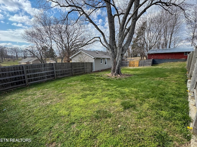 view of yard with a fenced backyard and an outdoor structure