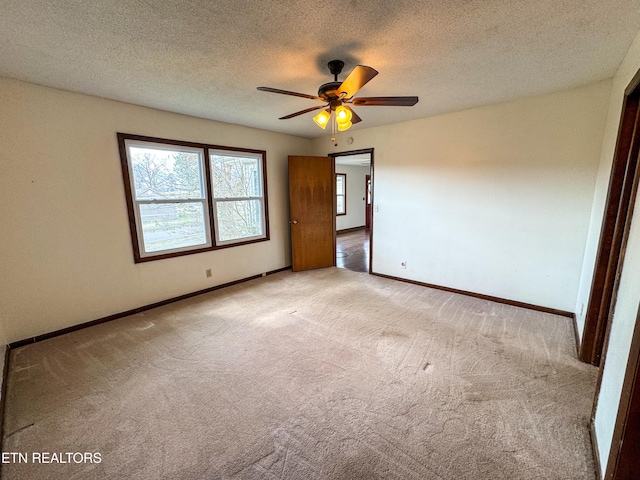 unfurnished bedroom featuring a textured ceiling, ceiling fan, carpet, and baseboards