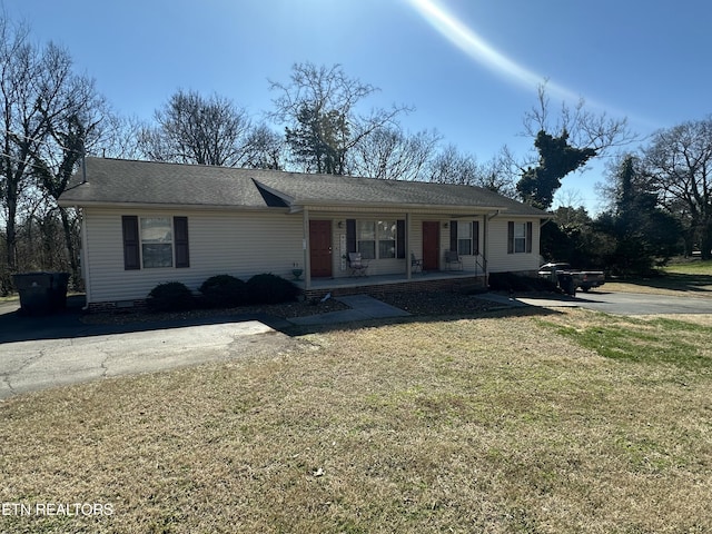 single story home featuring crawl space, covered porch, and a front lawn