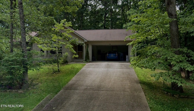 view of front of property featuring an attached garage and concrete driveway