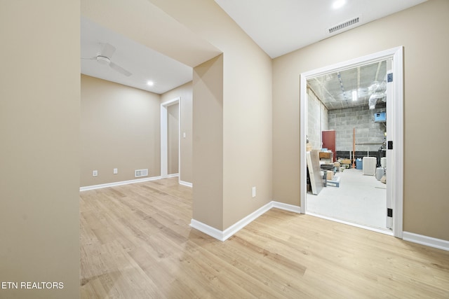 unfurnished room with visible vents, light wood-type flooring, and baseboards