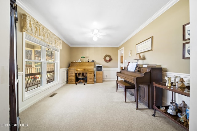 office with a wainscoted wall, crown molding, carpet flooring, and visible vents