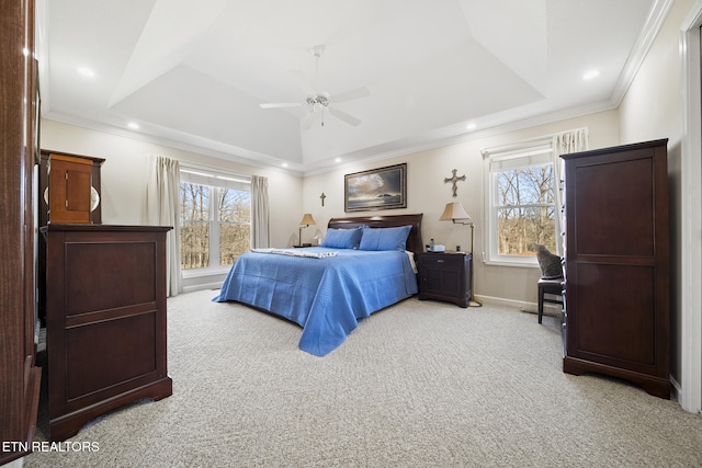 carpeted bedroom with a tray ceiling, recessed lighting, and crown molding