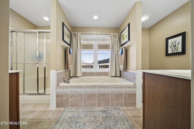 full bathroom featuring a bath, a stall shower, and vanity