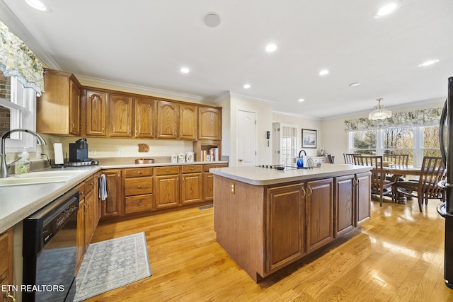 kitchen with light wood-type flooring, a sink, crown molding, light countertops, and dishwasher