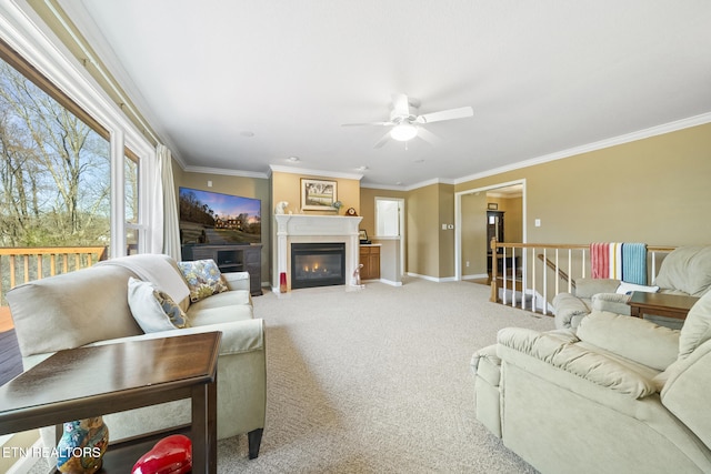 living area with a fireplace with flush hearth, light colored carpet, baseboards, and ornamental molding