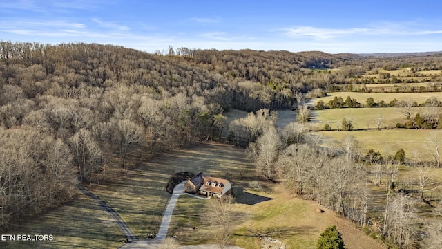 drone / aerial view with a view of trees and a rural view