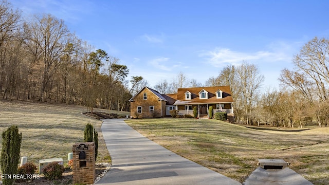 view of front of house with a porch and a front lawn