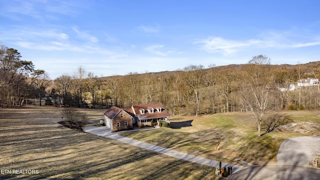 drone / aerial view featuring a forest view