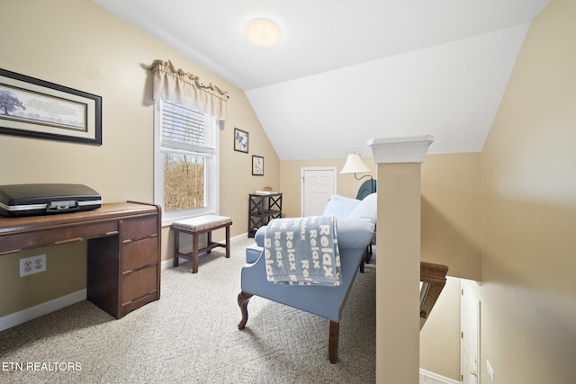 bedroom with vaulted ceiling, light colored carpet, and baseboards