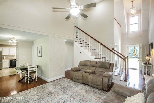 103 Branch Ln, Clinton, TN 37716 - living area with a towering ceiling, stairway, hardwood / wood-style flooring, a ceiling fan, and a chandelier