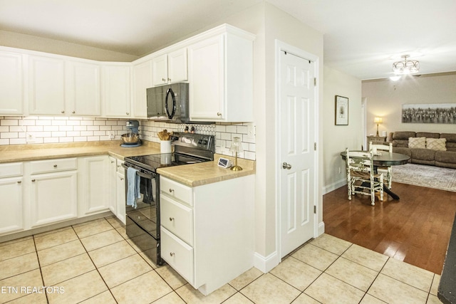 103 Branch Ln, Clinton, TN 37716 - kitchen featuring black appliances, light tile patterned flooring, open floor plan, tasteful backsplash, and light countertops