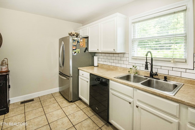 103 Branch Ln, Clinton, TN 37716 - kitchen with dishwasher, white cabinets, light tile patterned floors, freestanding refrigerator, and light countertops