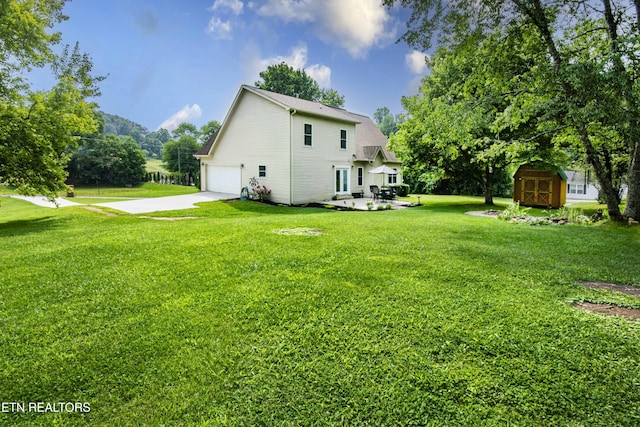 103 Branch Ln, Clinton, TN 37716 - rear view of house featuring a shed, a garage, concrete driveway, and a lawn