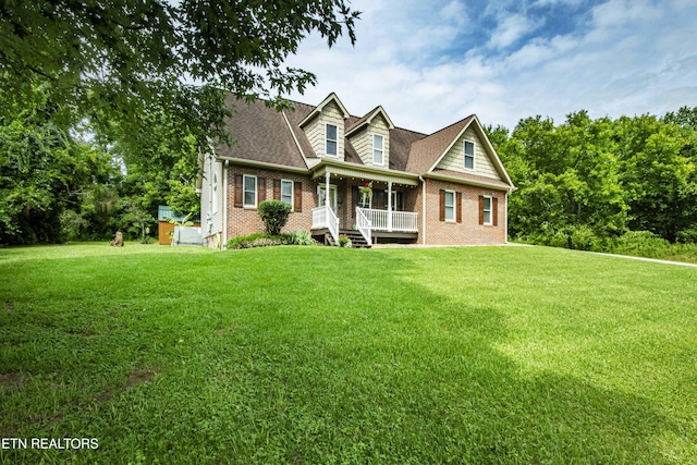 103 Branch Ln, Clinton, TN 37716 - cape cod house with brick siding, a porch, and a front yard