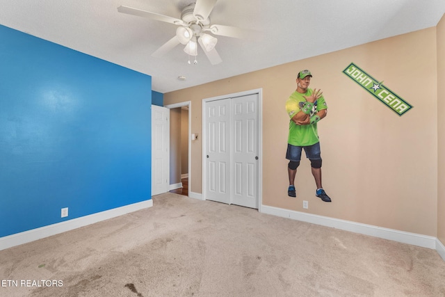 unfurnished bedroom featuring a closet, baseboards, and carpet