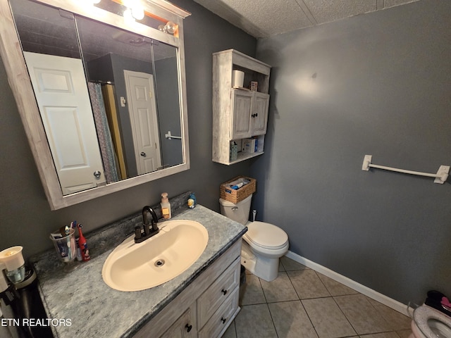 bathroom featuring tile patterned flooring, toilet, a shower with shower curtain, vanity, and baseboards