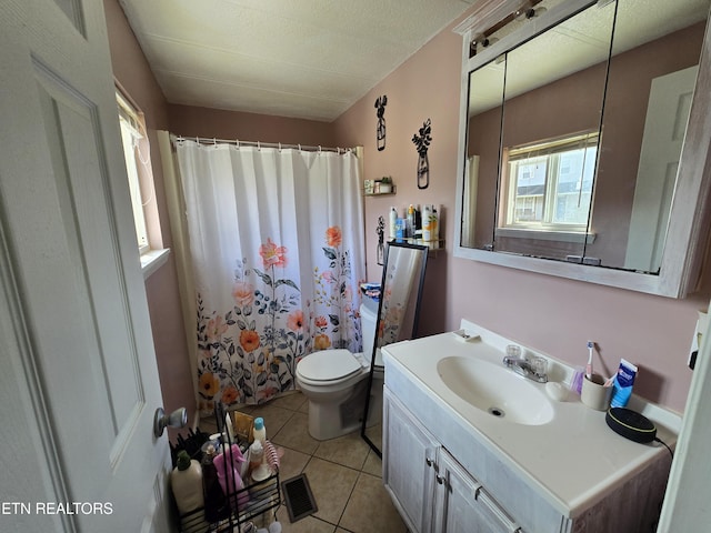 bathroom featuring toilet, a shower with curtain, vanity, and tile patterned floors