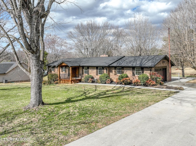 single story home featuring an attached garage, brick siding, driveway, a front lawn, and a chimney