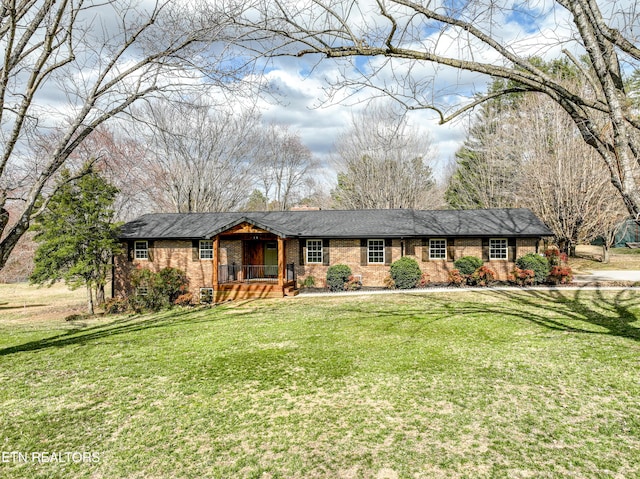 single story home with a porch, a front lawn, and brick siding