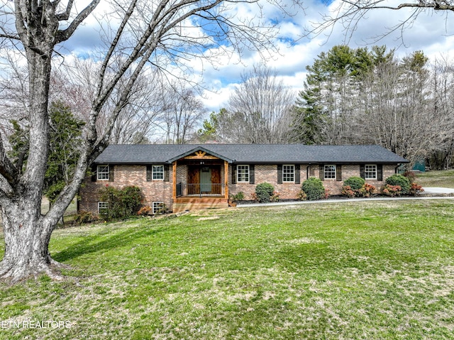 ranch-style house featuring covered porch, a front lawn, and brick siding