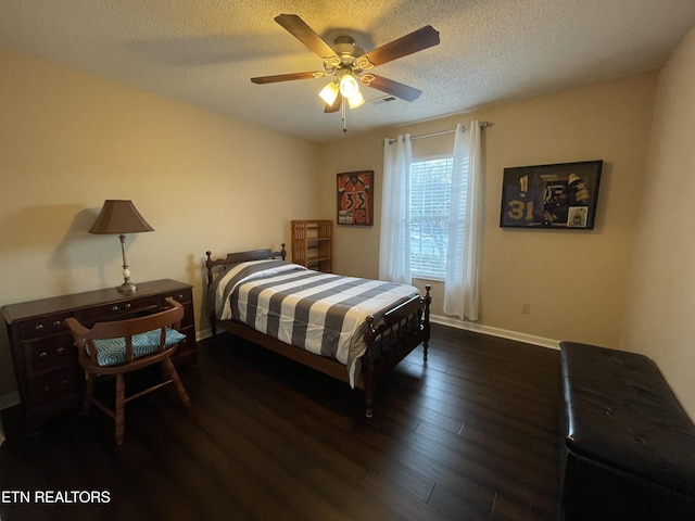 bedroom with a ceiling fan, wood-type flooring, baseboards, and a textured ceiling