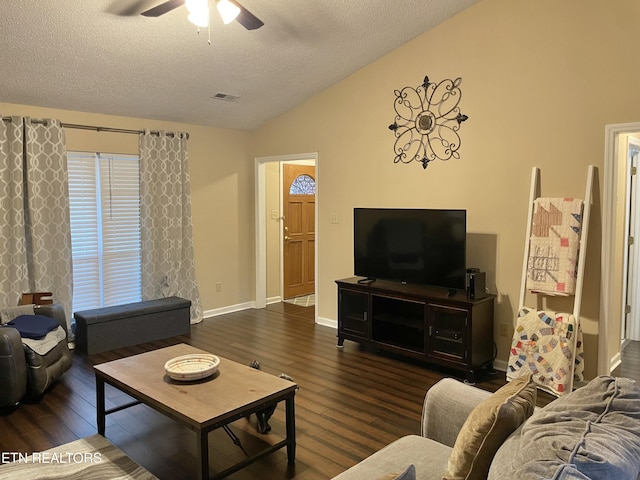 living area with visible vents, a ceiling fan, lofted ceiling, wood finished floors, and a textured ceiling