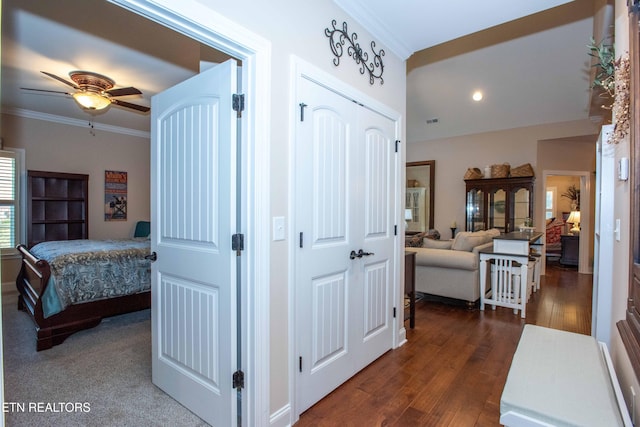 hall with ornamental molding and dark wood-type flooring