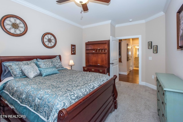 carpeted bedroom with baseboards, a ceiling fan, and crown molding