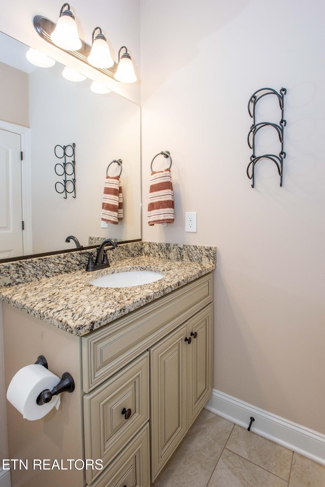 bathroom featuring tile patterned flooring, vanity, and baseboards