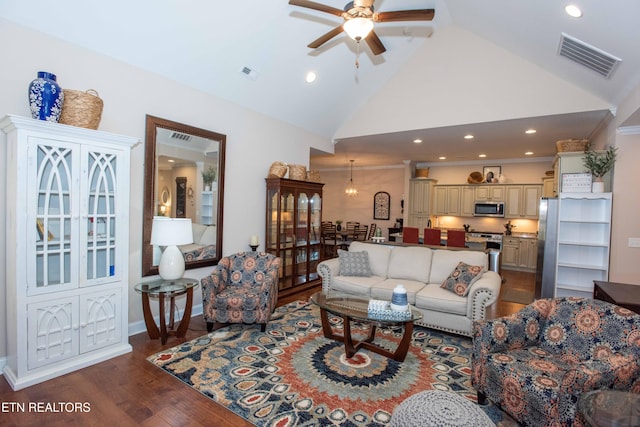 living area featuring high vaulted ceiling, ceiling fan, visible vents, and wood finished floors