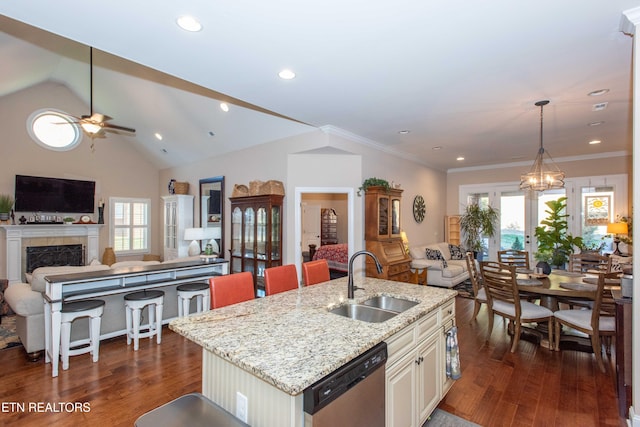 kitchen with dishwasher, dark wood finished floors, open floor plan, and a sink